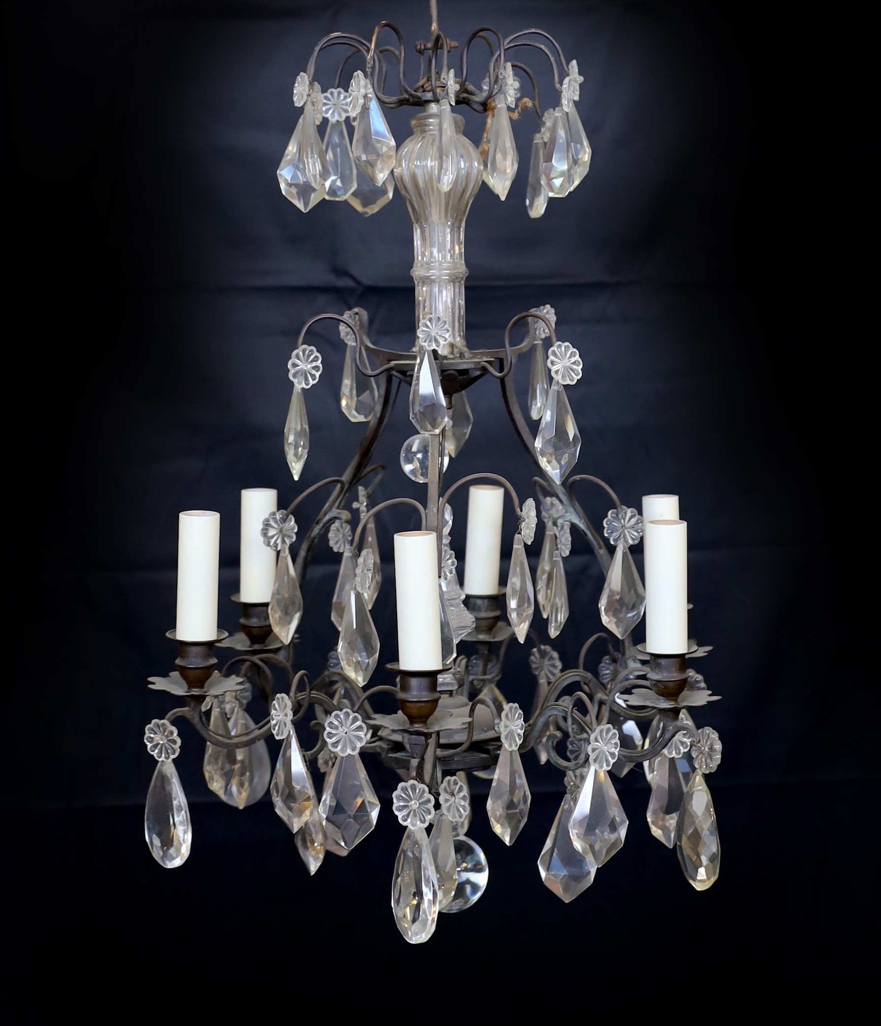 An early 20th century French bronze and cut glass six light chandelier hung with tear shaped and faceted drops, height 63cm. width 42cm